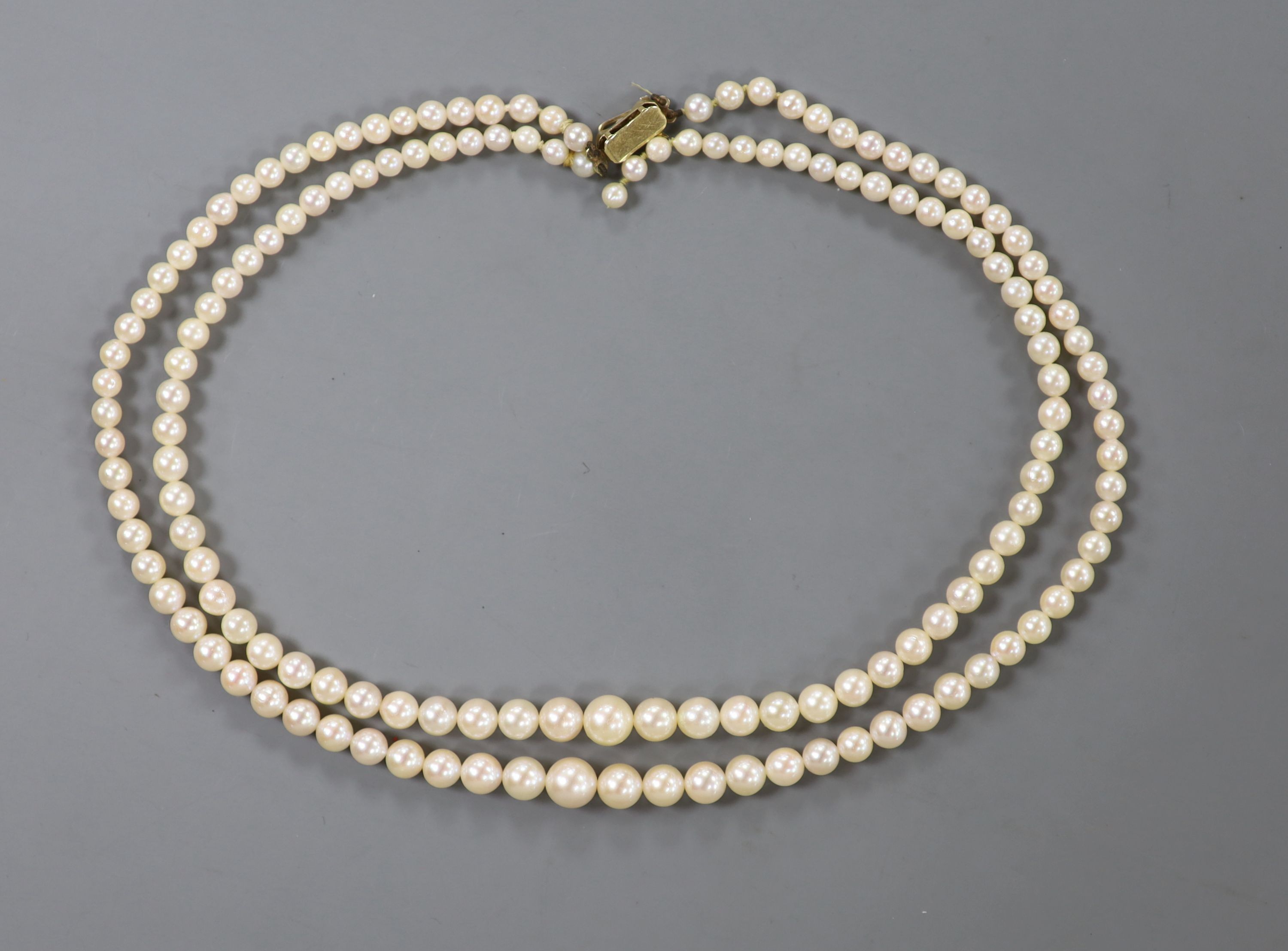 A double strand graduated cultured pearl necklace, with 9ct gold and cultured pearl set clasp, approx. 40cm.